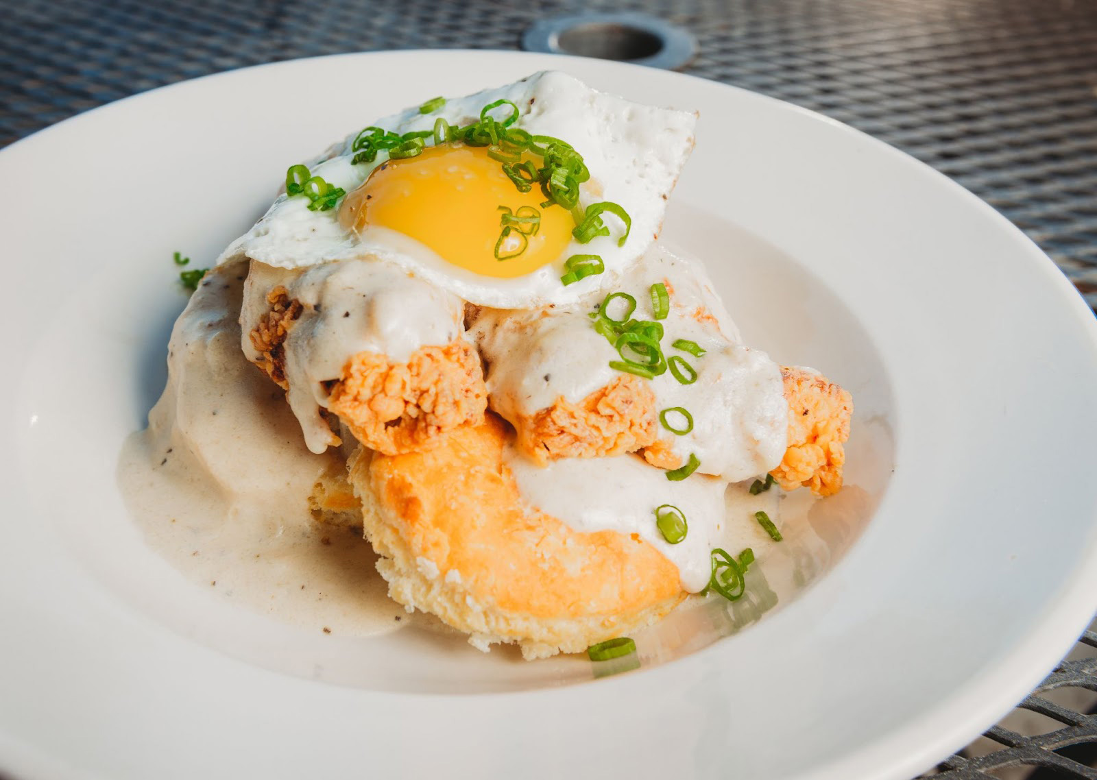 A plate featuring a fried egg atop a biscuit served at a seafood restaurant on the Oregon coastjpg