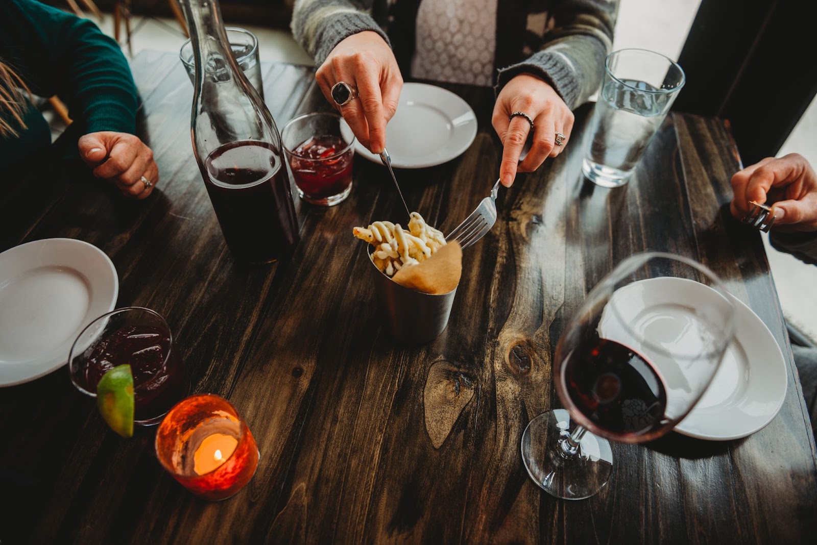 A group of people enjoying gourmet food and wine at a beautifully set table showcasing Myril caterings exquisite offeringsjpeg