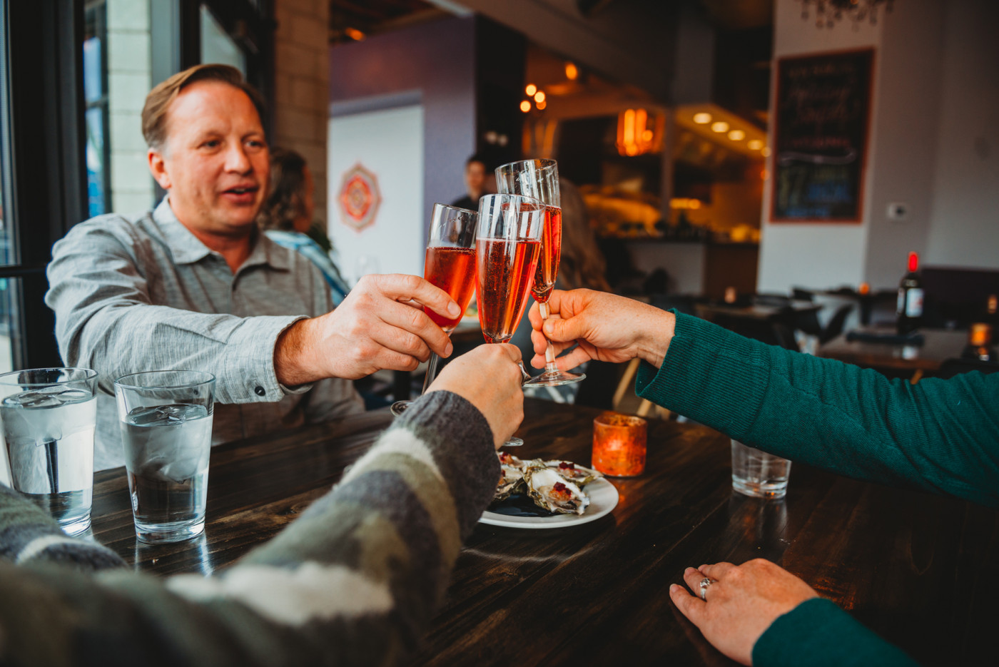 A group of people enjoying a meal at a table with plates of food Wine Pairing Pairing Food and Wine Eatery